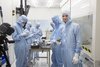 Picture of five AU students, with Kåre Jensen on the far right, working on their Delphini-1 satellite